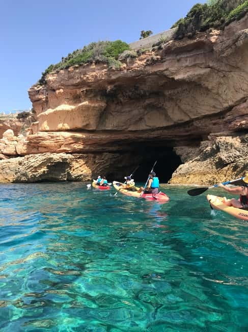 Cala Codolar: Guided Sea Kayaking and Snorkeling Tour - Stop-by-stop: kayaking scenes, then a snorkeling break in clear water