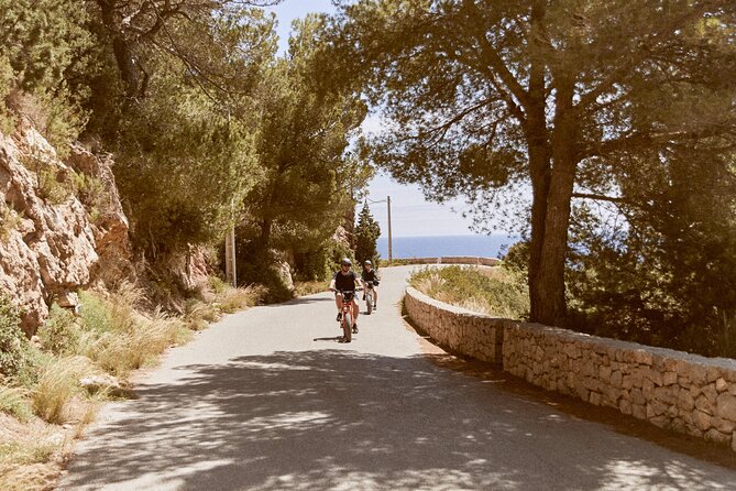 Guided Ebike Tour in Ibiza - Cala Nova: clear blue water, snorkel-friendly rocks, and surf-current caution