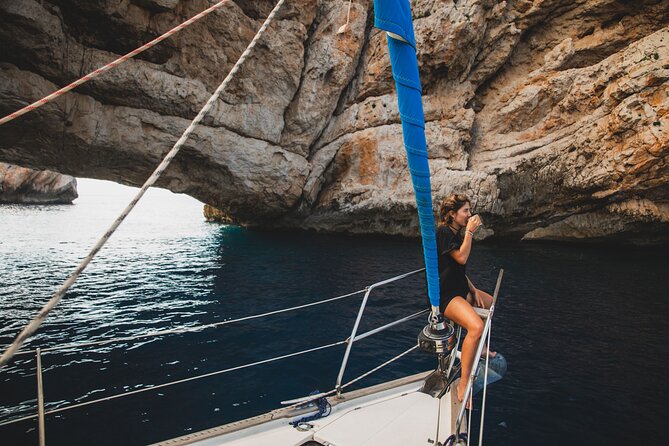 Half Day Private Sailboat around Ibiza's Coves - Stop 3: Es Cubells / Cala Es Torrent—slow down by reddish cliffs