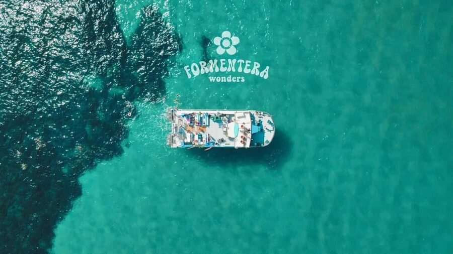 Ibiza: Boat Trip to Formentera with Open Bar and Paella - The boat experience: slide, shade, and optional Balinese sunbeds