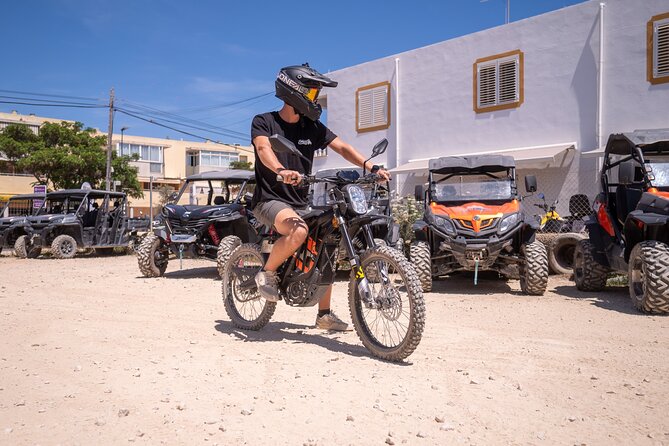 Ibiza: Electric Motorbike Excursion - Porroig natural bay: boats at rest under dramatic views