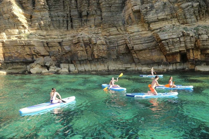 San Antonio: Cala Salada & Cala Gracio Sunset Boat Trip - Onboard comfort: open bar, Spanish tapas, and the feel of the ride